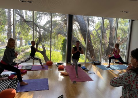 Yoga in der Halle mit Panoramablick nach draußen
